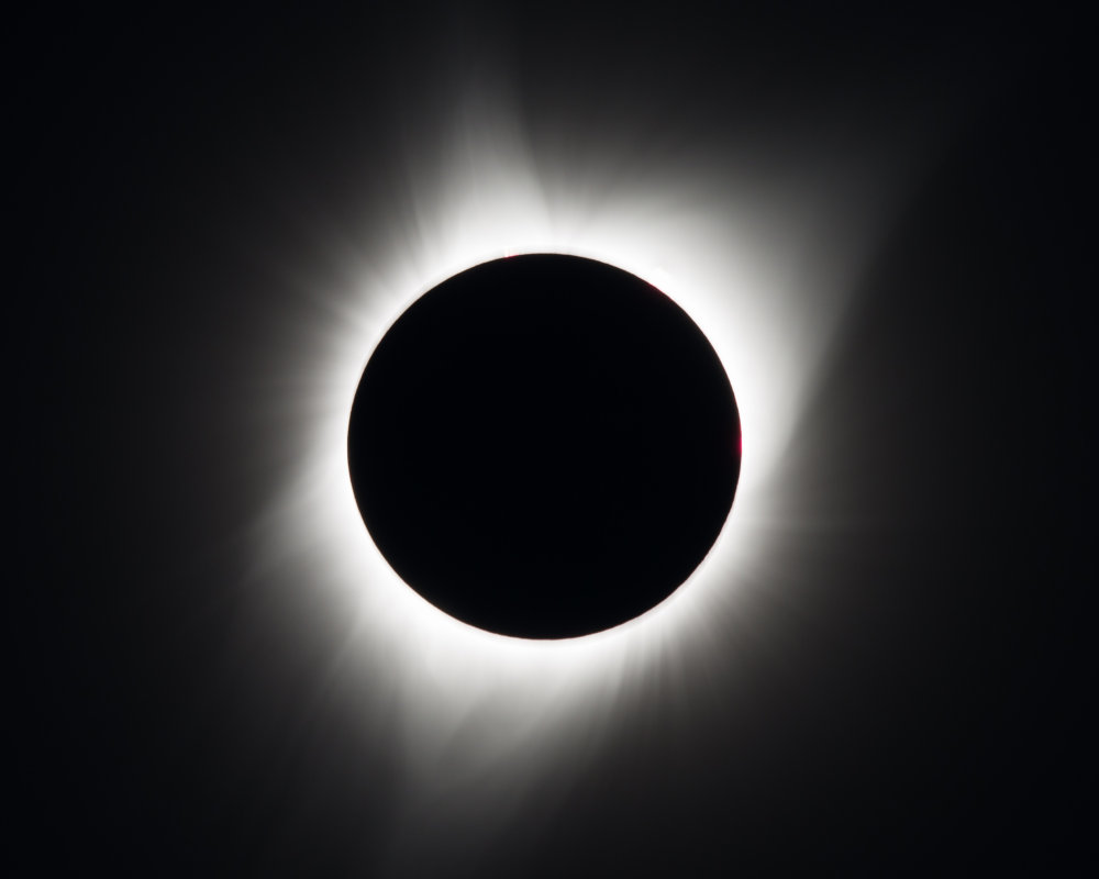 A total solar eclipse is seen on Monday, August 21, 2017 above Madras, Oregon. A total solar eclipse swept across a narrow portion of the contiguous United States from Lincoln Beach, Oregon to Charleston, South Carolina. A partial solar eclipse was visible across the entire North American continent along with parts of South America, Africa, and Europe.  Photo Credit: (NASA/Aubrey Gemignani)